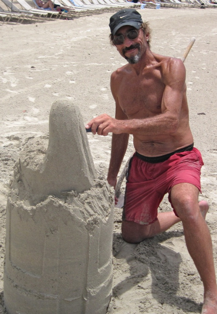 Larry Safady begins work on a sand-sculpture pelican.
