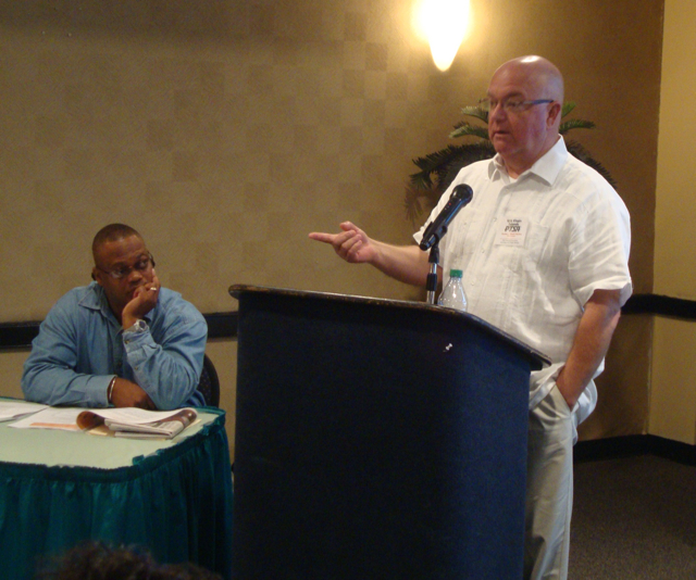 Charles Saylors, right, the president of the National PTA, speaks to the V.I. convention while Alvin Bedneau listens.