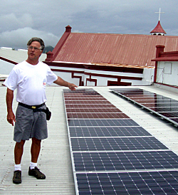 Beech Higby of West Indies Solair shows off the solar panels he installed on the roof of St. Ann's Catholic Church.