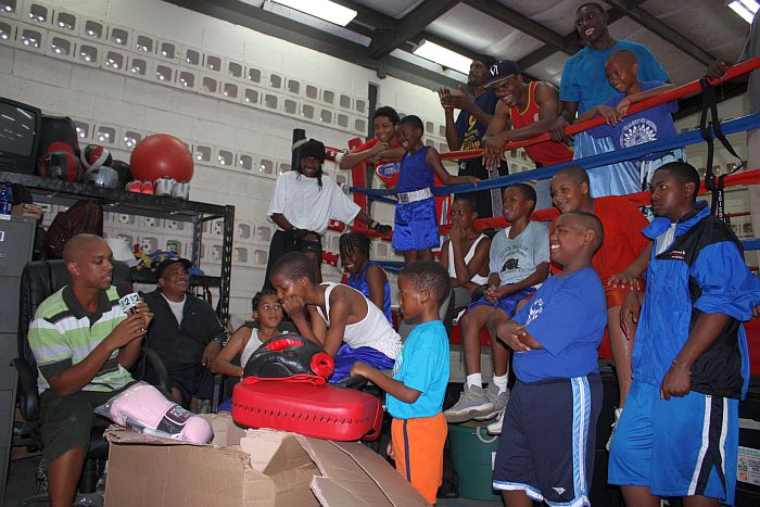 Caribbean Education Initiative representative Rashidi Clenance (left) presents the V.I. Boxing Federation with its new equipment.