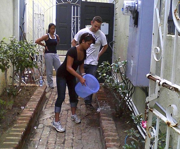 University of Michigan student Kat Autin joins fellow classmates in a cleanup of the St. Thomas Historical Trust building Wednesday.