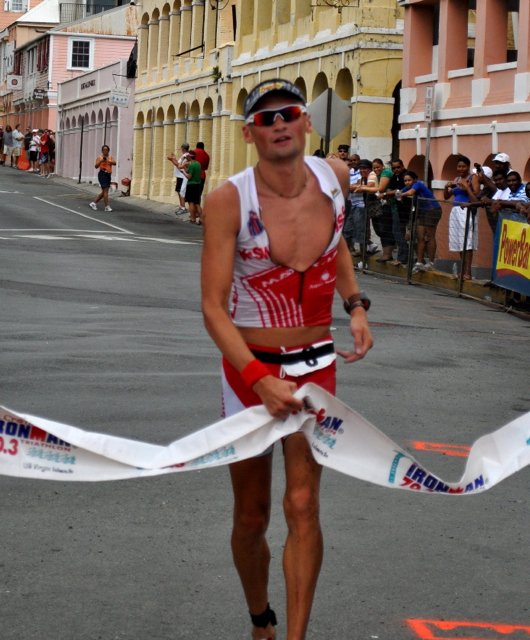 Maksym Kriat of the Ukraine crosses the finish line in the St. Croix Ironman 70.3 Triathlon.