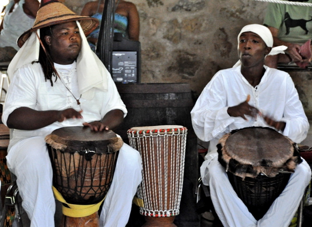 Anua and Anuptah Kahina pound out a rhythm for the Per Ankh Dance Troupe.