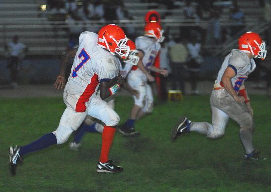 Arawak's Bradley Fessale (7) returns a punt with blockers out front. 