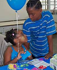 Gelysia Anderson (left) and Giovanni Anderson enjoy crafts Sunday.