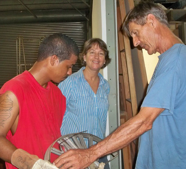 Jose Lopez (from left), Barbara and Mike Walsh look over grill work.