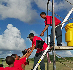 Junior Firefighters Corps members take part in the bucket brigade.