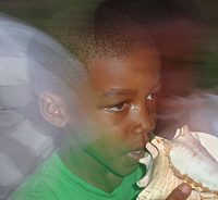 A 6-year-old Crucian boy learns to blow the conch.