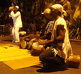Drummers and conch player gather the community to mark Fireburn.