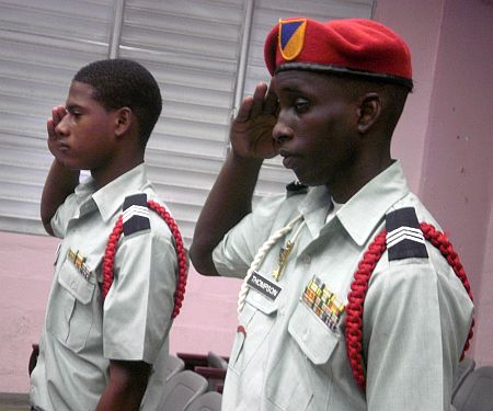 Charlotte Amalie High School JROTC Cadets Alvante Frett (left) and T.J. Thompson, salute the flag during Monday's ceremony.