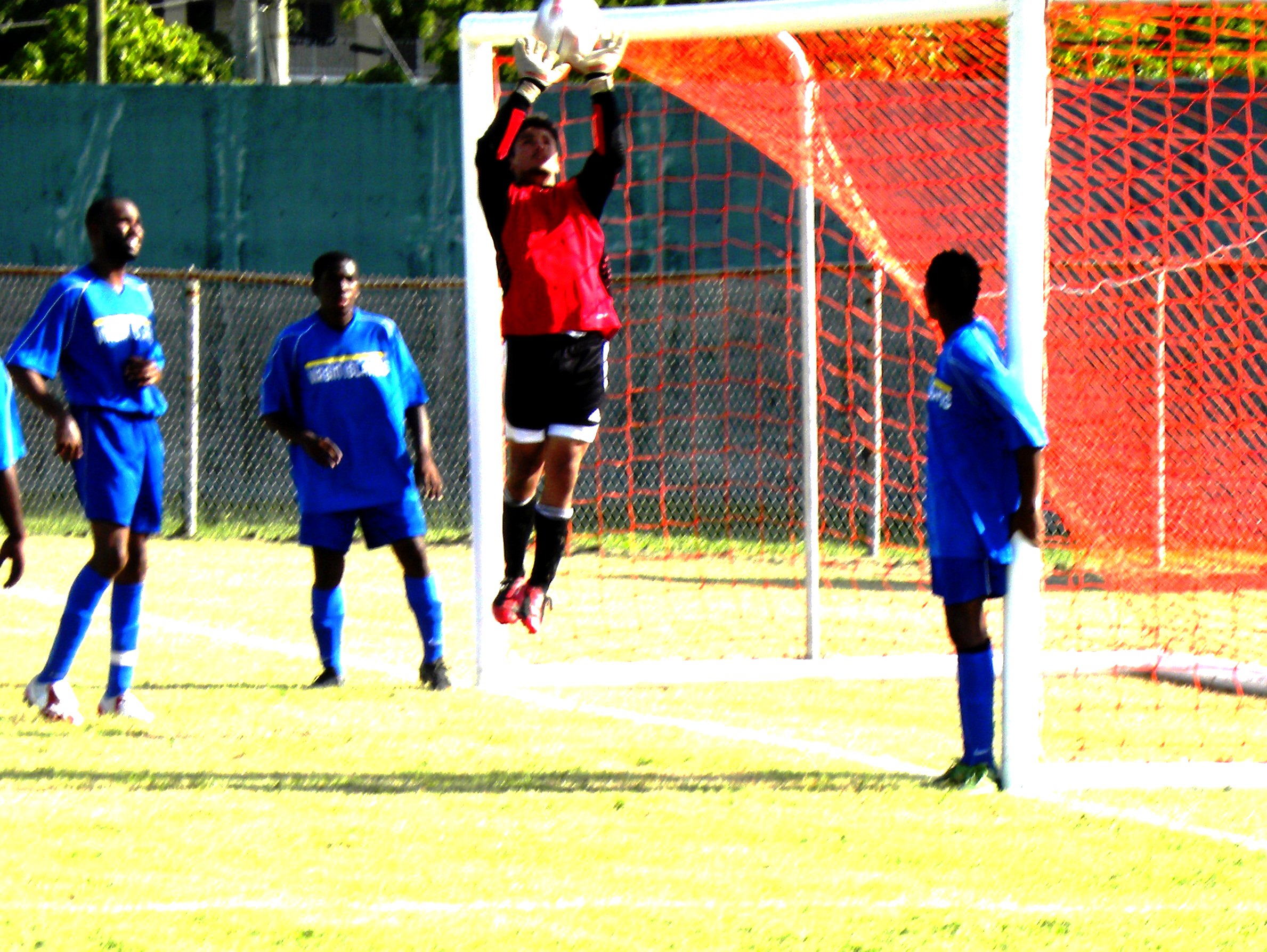 UVI goalkeeper Troy Miessau goes high to collect a corner kick.