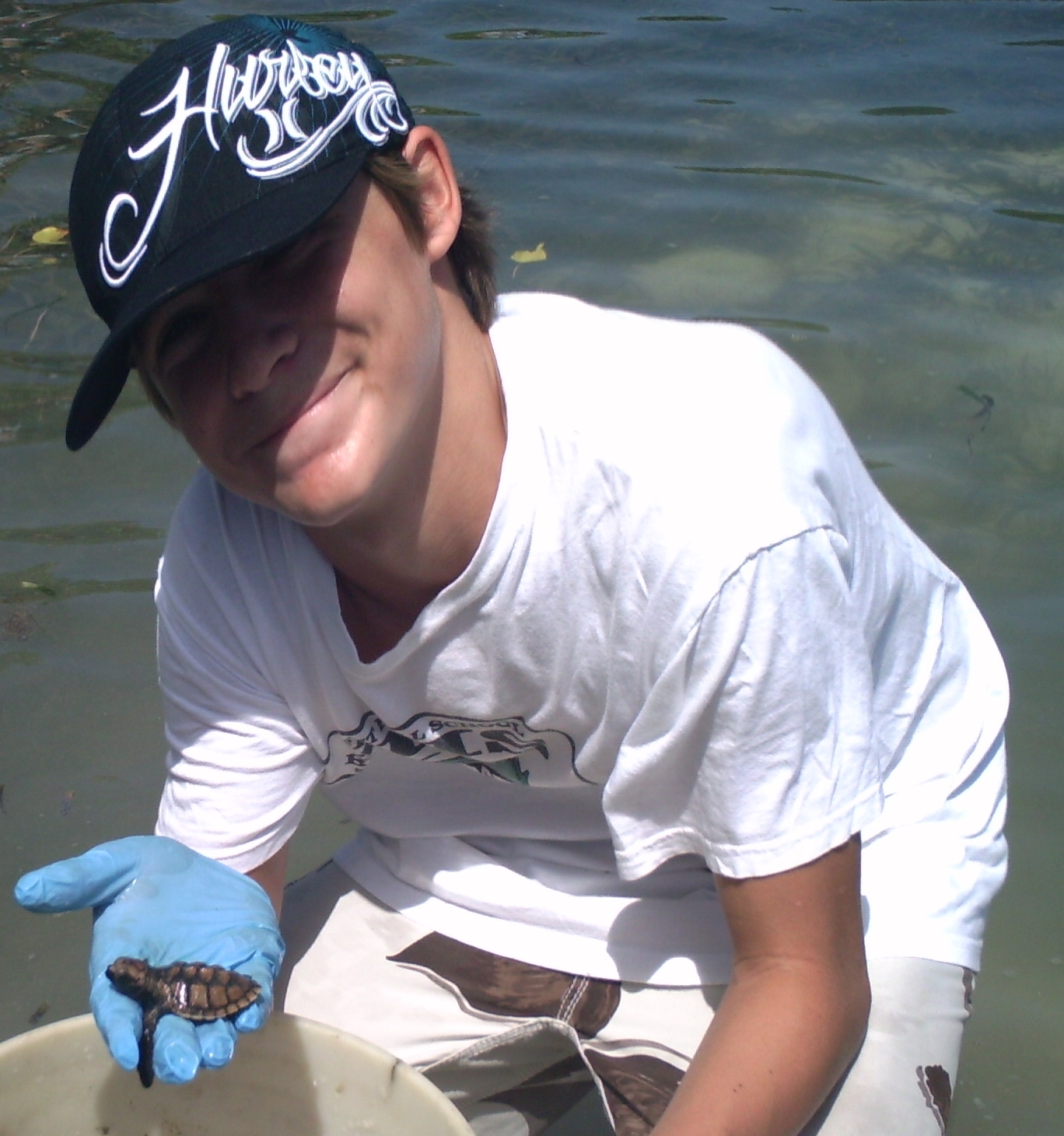Coastweeks volunteer Luke Patrie and the turtle. (Photo courtesy Laurel Brannick)