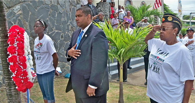 From left, Vielka White,  Gov. John deJongh Jr.and Annie Day-Henry of American Legion Post 102 lay wreath. (Carol Buchanan photo)