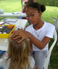 Jahniqua Cintron paints faces in the Children's Tent.