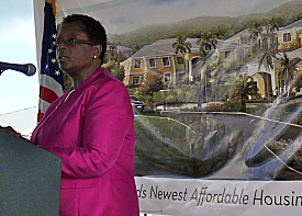 Assistant Secretary of HUD Sandra Henriquez speaks Friday with a rendering of the Louis E. Brown Villas as backdrop.