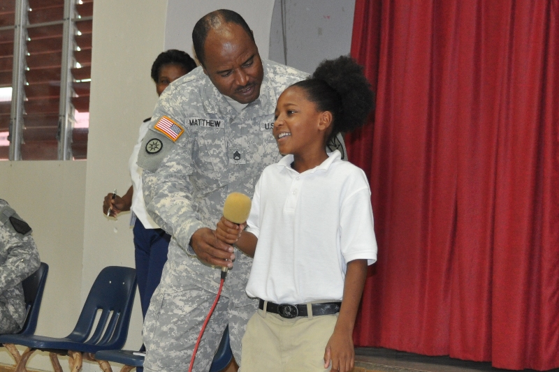 Staff Sgt. Elroy Matthew invites 11-year-old Colly Cascen up to help define "watch tower."