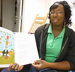 Mother Goose trainer Kimberly Thomas shows off a picture book.