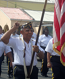American Legionnaire Cleofe Asencio carries Old Glory in the St. Croix parade.