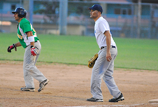 The Hurricanes' Carlos Morales (left) takes a lead off of first after a fourth inning two-run single.