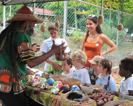 Delroy “Ital” Anthony (left) shows youths seeds and other natural materials used in his arts and crafts.