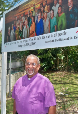 Rev. Rafael Quinones and the HIV/AIDS awareness sign at the Hispanic Methodist church.