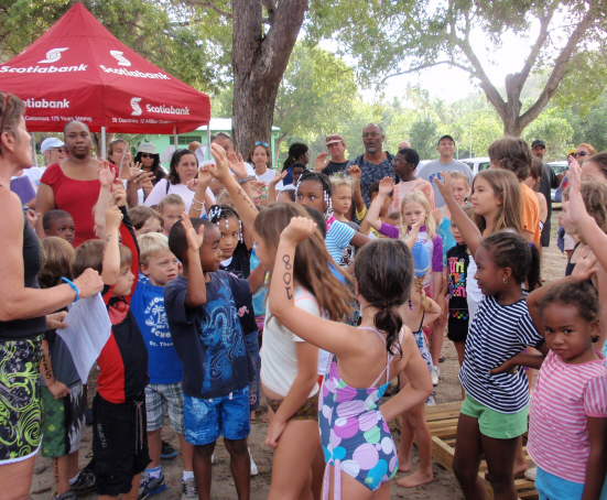 Accomplished triathlete Jude Woodcock (left) gets kids psyched for learning triathlon skills.