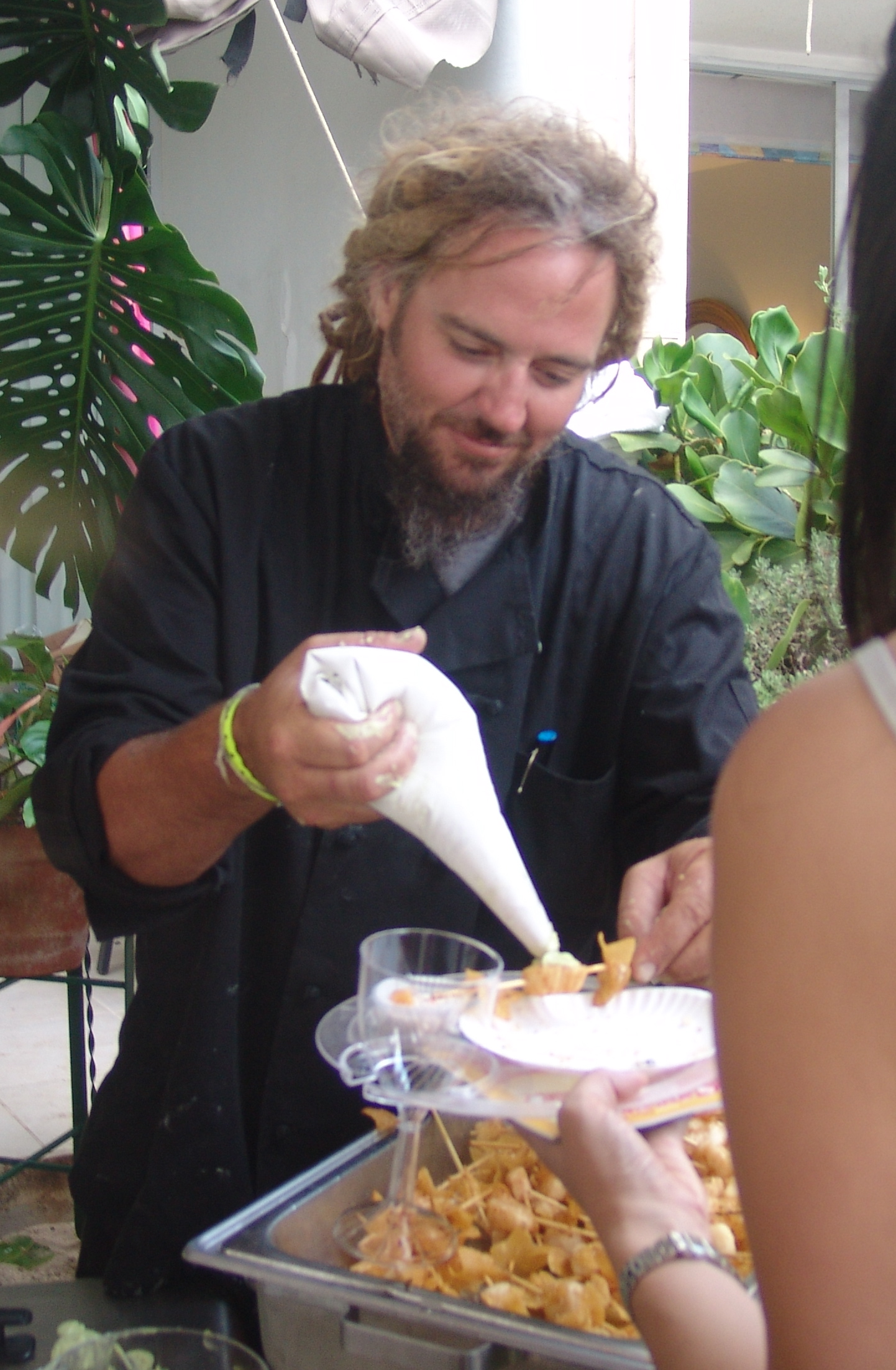 Savant executive chef Eric 'Dreads' Nielsen spreads wasabi butter on a scallop.