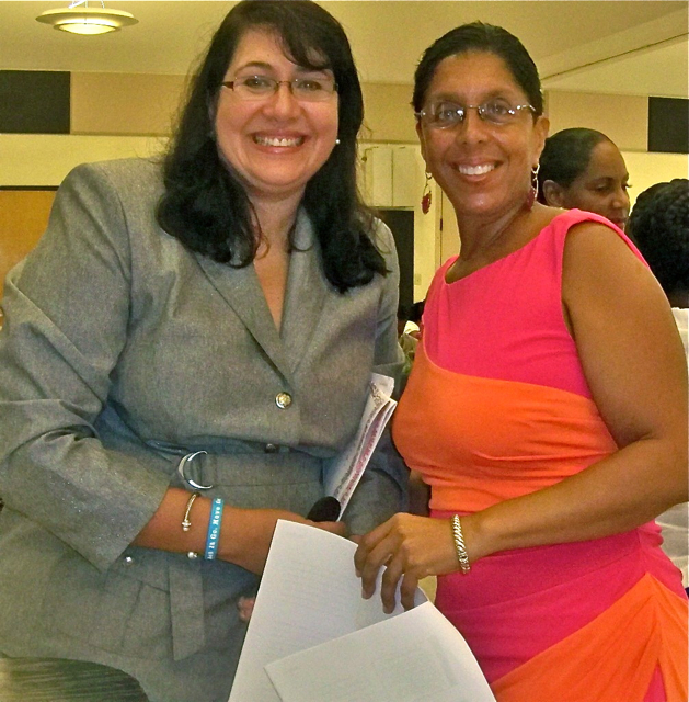 Dr. Lillian Santos, left, and Yvonne Galiber at Saturday's cancer awareness conference. 