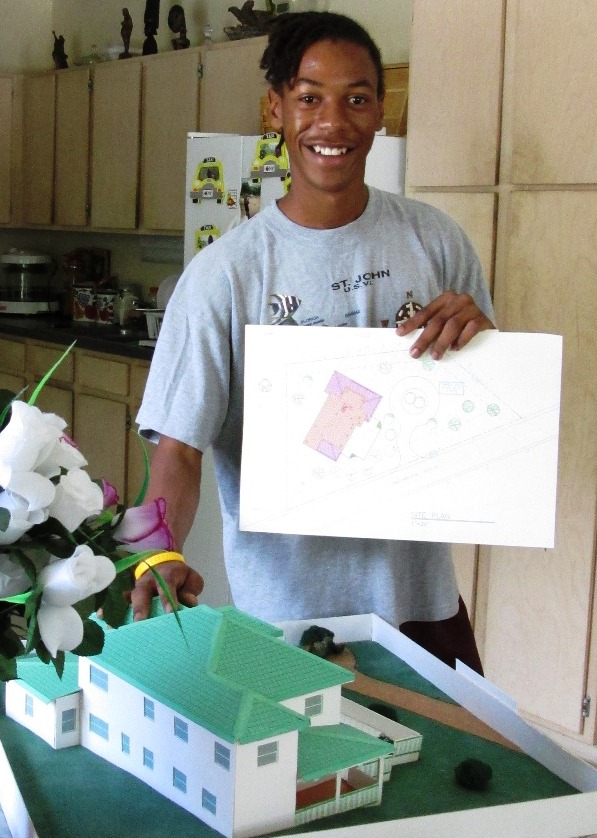 Loran Jackson with the model of the house he designed for his high school architecture class.
