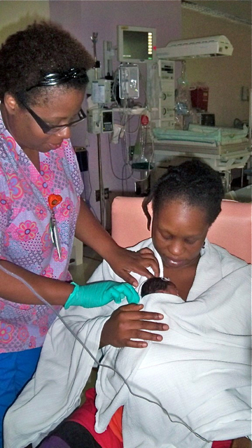 Nurse Faye John-Baptiste helps Lakeisha Iles hold baby Liniyah for the first time. 