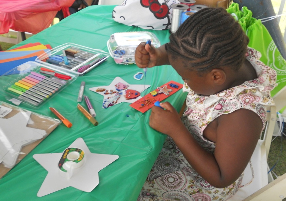 Destine Jarvis, 7, concentrates on making a bookmark at Saturday's Summer Reading Challenge activity.