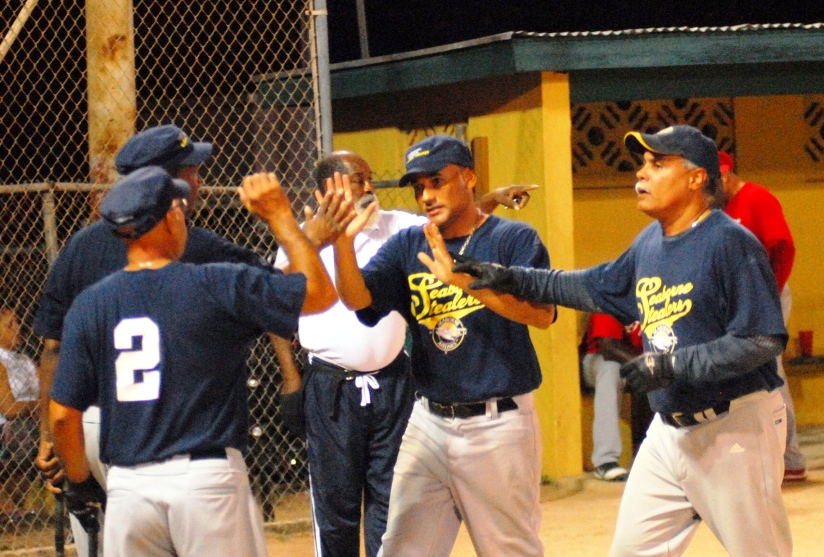Angel Torres is congratulated by Stealers teammates at home plate after a three-run blast Monday at Canegata ballpark.