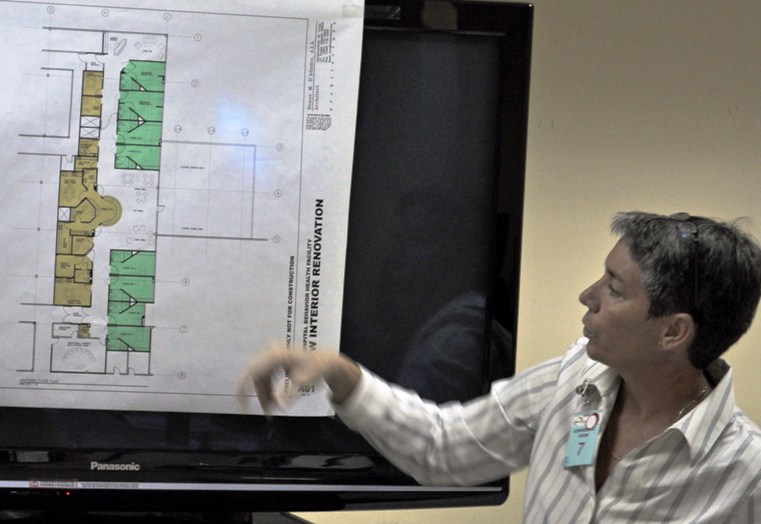 An architect shows JFL board members and staff updated renovation plans regarding the hospital's recently closed behavioral health unit.