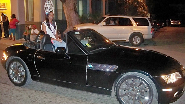 Miss St. Croix, Cliaunjel Williams, rides in the back of a BMW convertible.