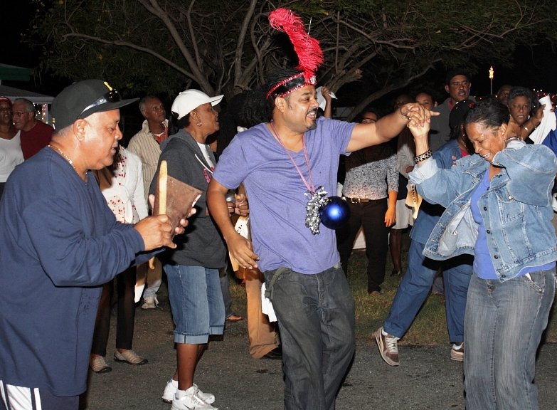 Revelers dance and play along with the music during the Crucian Christmas Serenade.