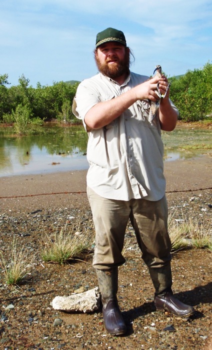 Biologist Fletcher Smith of the Center for Conservation Biology holds Hope in Great Pond after removal of the transmitter in November (Photo courtesy of CCB).