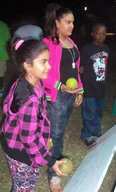 Krystal Sarran, left, and Miah Sarran play a carnival game.