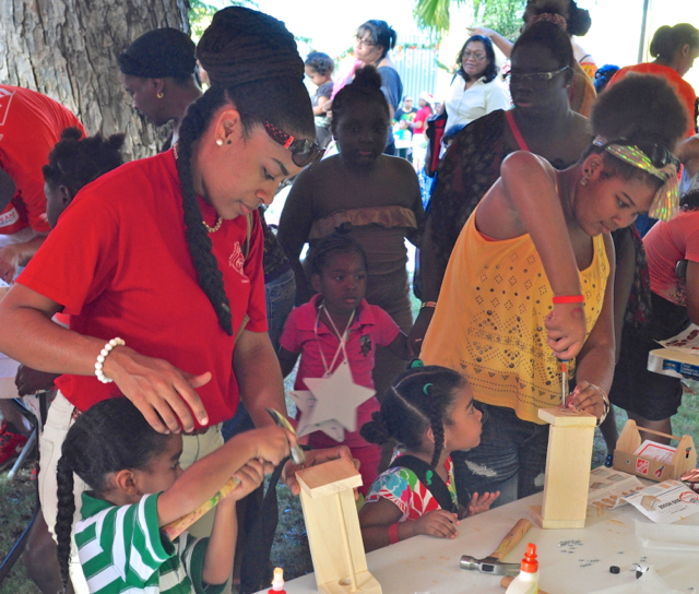 From left, Jediah Ramos, his mother Evernie Ramos, Jeniyah Ramos and Allayra Murphy build a wooden bug house supplied by sponsor Home Depot.