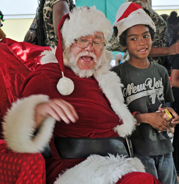 Santa Clause reaches for a gift for Trestan Herman at the children’s Christmas party. Santa Clause reaches for a gift for Trestan Herman at the children’s Christmas party.