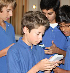 Antilles School's Nicholas Midler (front) calculates a problem with his teammates.