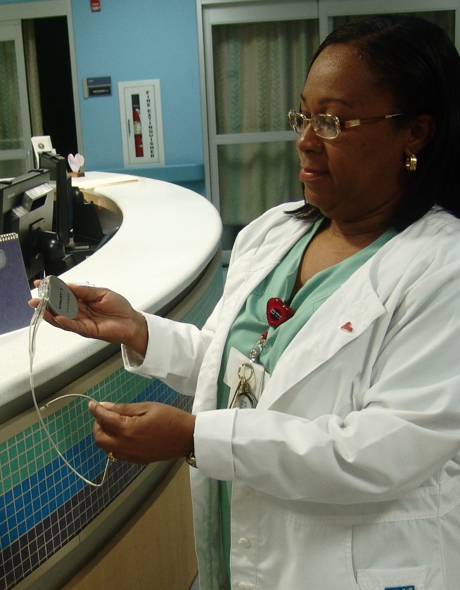 Nurse manager Lorie Trotman displays a pacemaker.