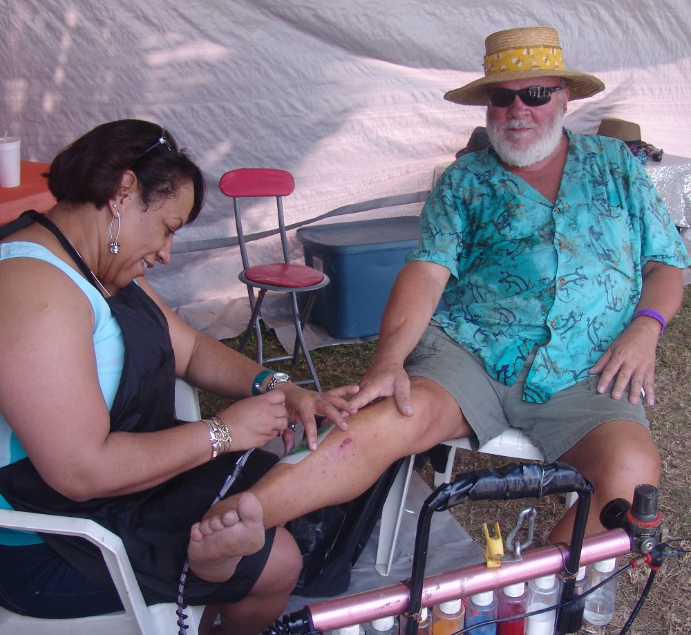 Aaron Morris of Saratoga, N.Y., gets a gecko temporary tattoo from Felicia Henry at the 41st Annual Agriculture and Food Fair.