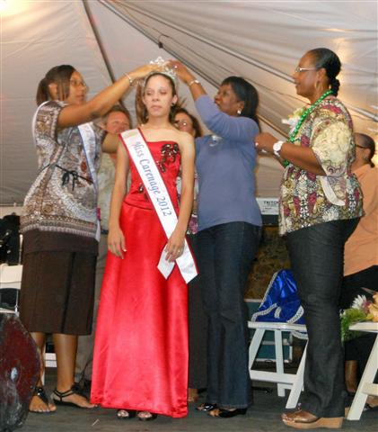 Miss Carenage 2012 Christine Greaux, center, is crowned by Miss Carenage 2011 Jessica Bute,left, and Cheryl Francis, right, while Barbara Petersen St. Thomas-Water Island administrator looks on.