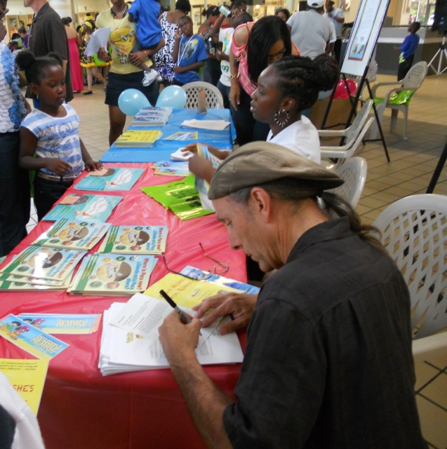 Author Mario Picayo signs books with apersonalized message for each student.