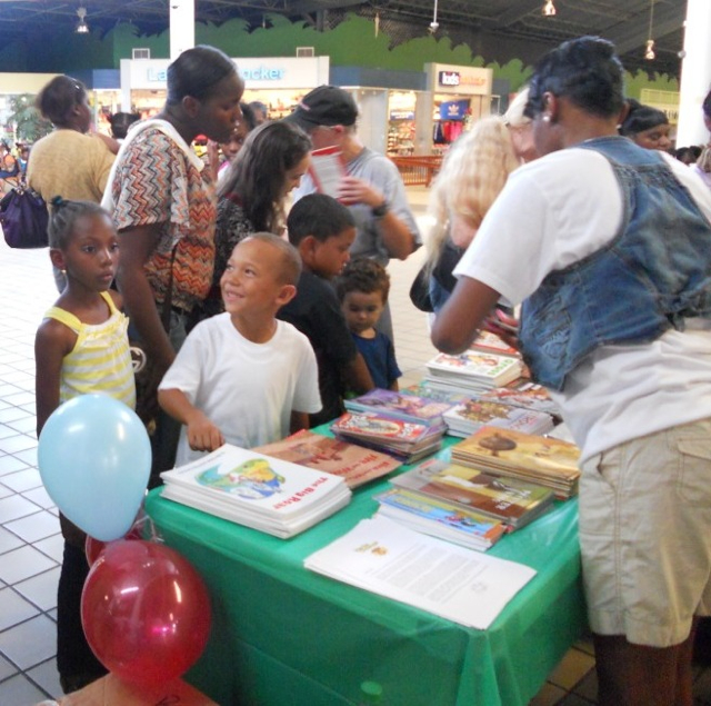 Excited children pick out books for their summer reading.