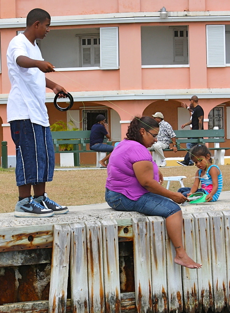  Linda Rivera teaches her 4-year-old daughter, Jaylyne, how to fish while her 12-year-old son, Jose, casts from the wharf.