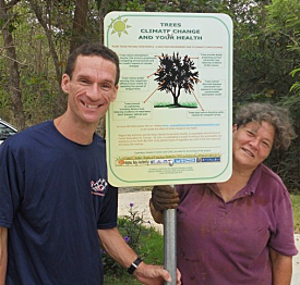 Jason Budsan and Katina Coulianos put up a climate change sign Sunday as well.