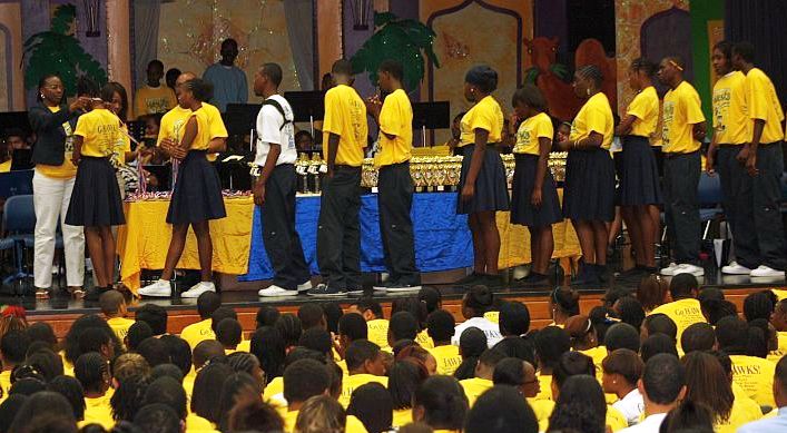 CAHS student achievers dressed in celebratory gold T-shirts to receive their medals and trophies.