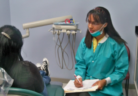 Dentist Talia Moses witih a patient.
