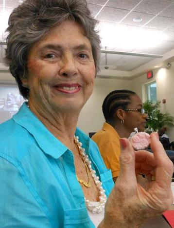 Entrepeneur Ivanne Farr holding a brooch made from local conch at her studio.